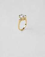 Oval and Baguette Three Stone Engagement Ring — Yellow gold