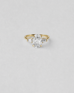 Oval and Baguette Three Stone Engagement Ring — Yellow gold